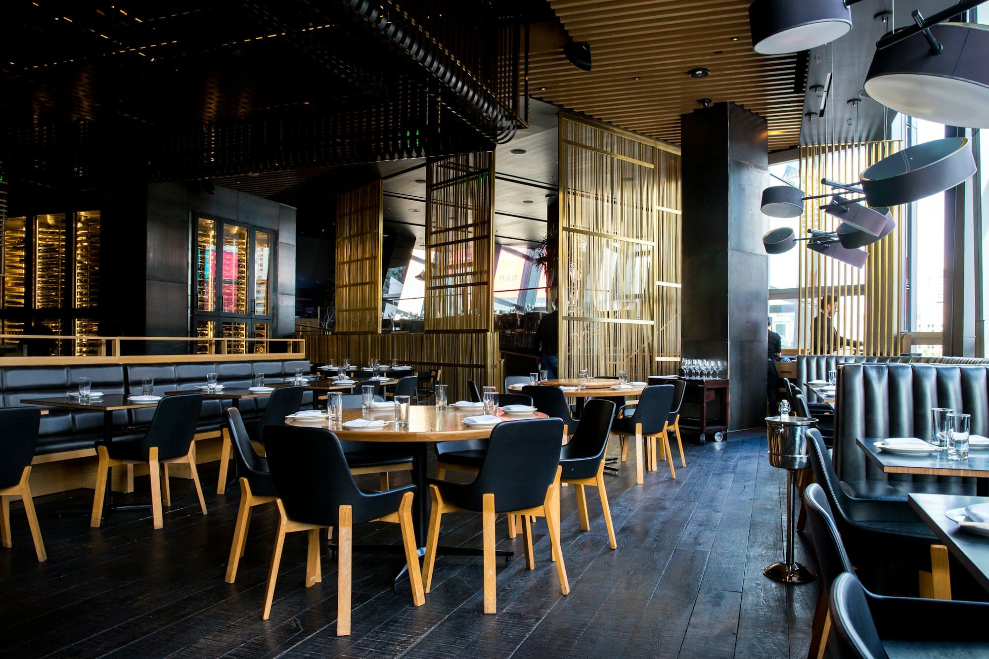 A dark, modern restaurant dining room at night